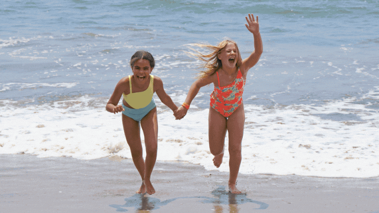girls running on the beach