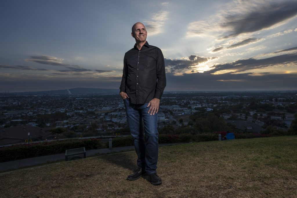 Headshot of Brett Sanders on a hill at evening