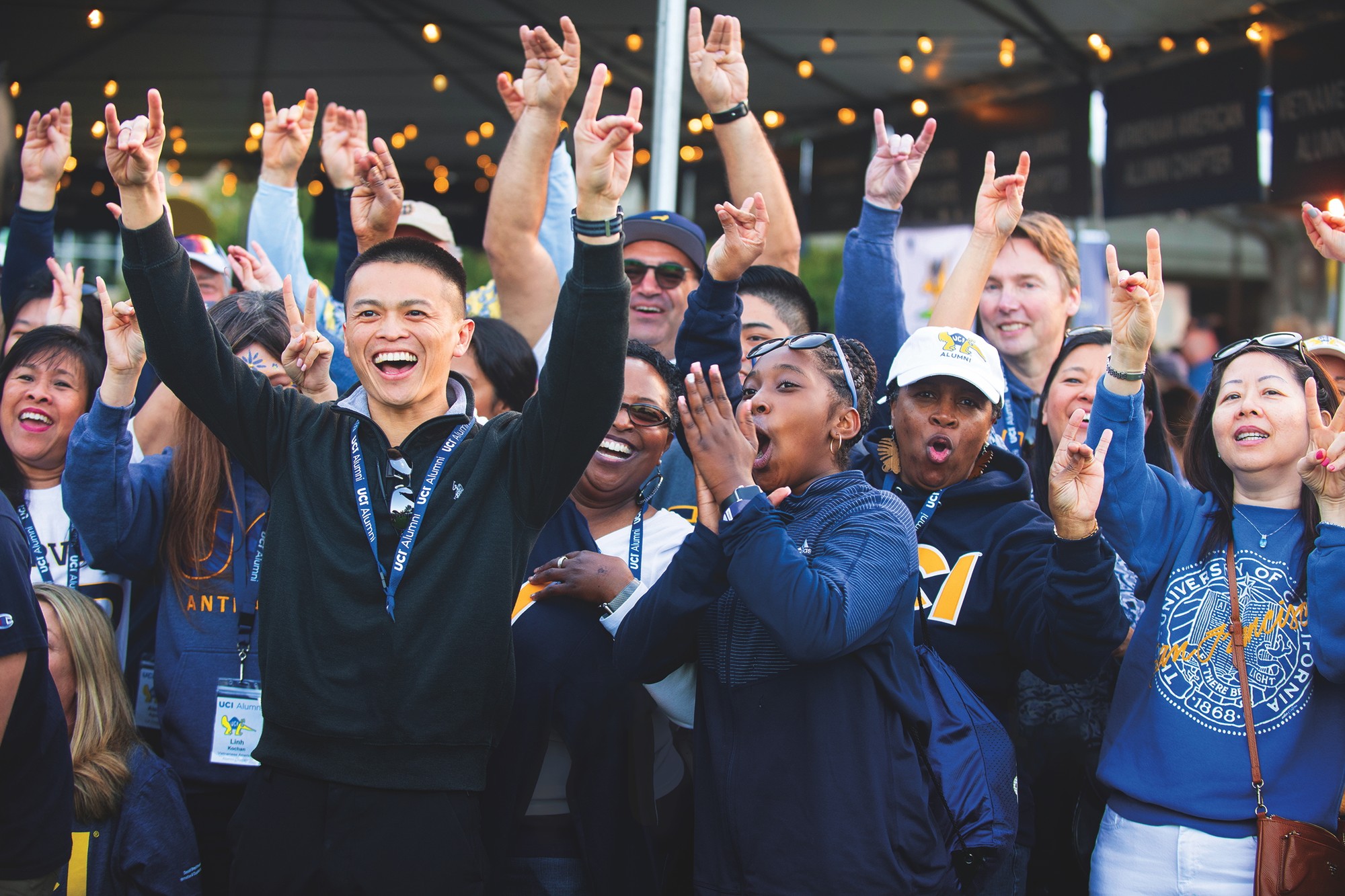 Excited UCI alumni cheering at Homecoming
