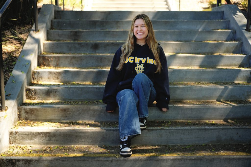 UCI alumna wearing the signature UCI sweatshirt