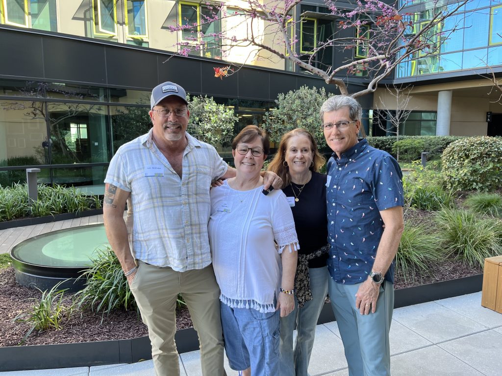 Les McCabe, Jill Halvaks, Dave Mayo, and Lori Miller-Bath pose outside in a courtyard
