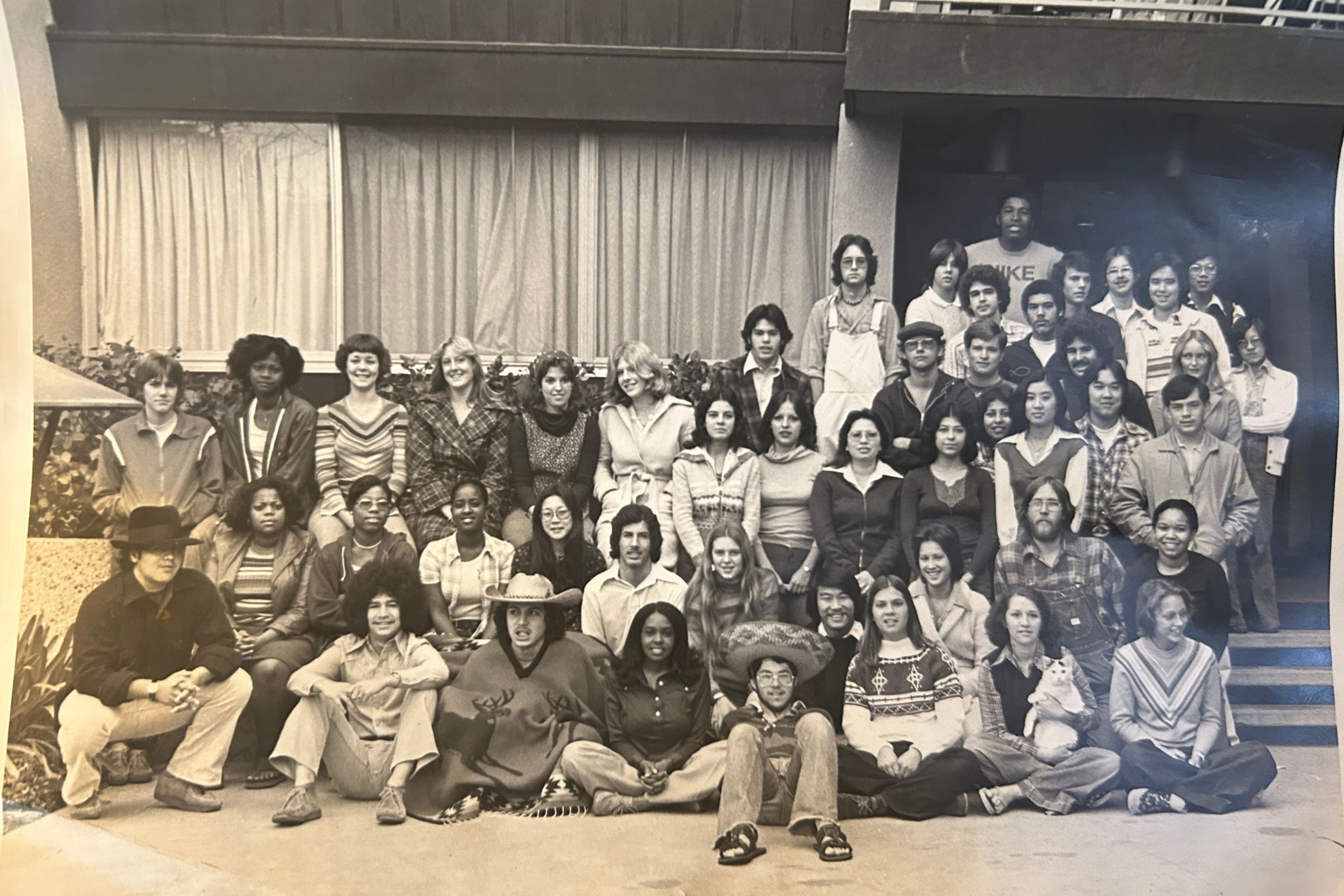 A black and white photograph of students in front of a residence building