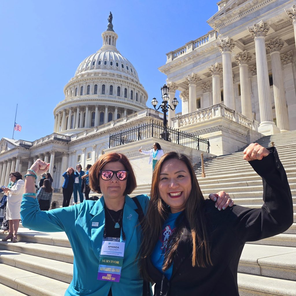 Schneider genuflexes her bicep with a colleague on the steps of the Capitol building