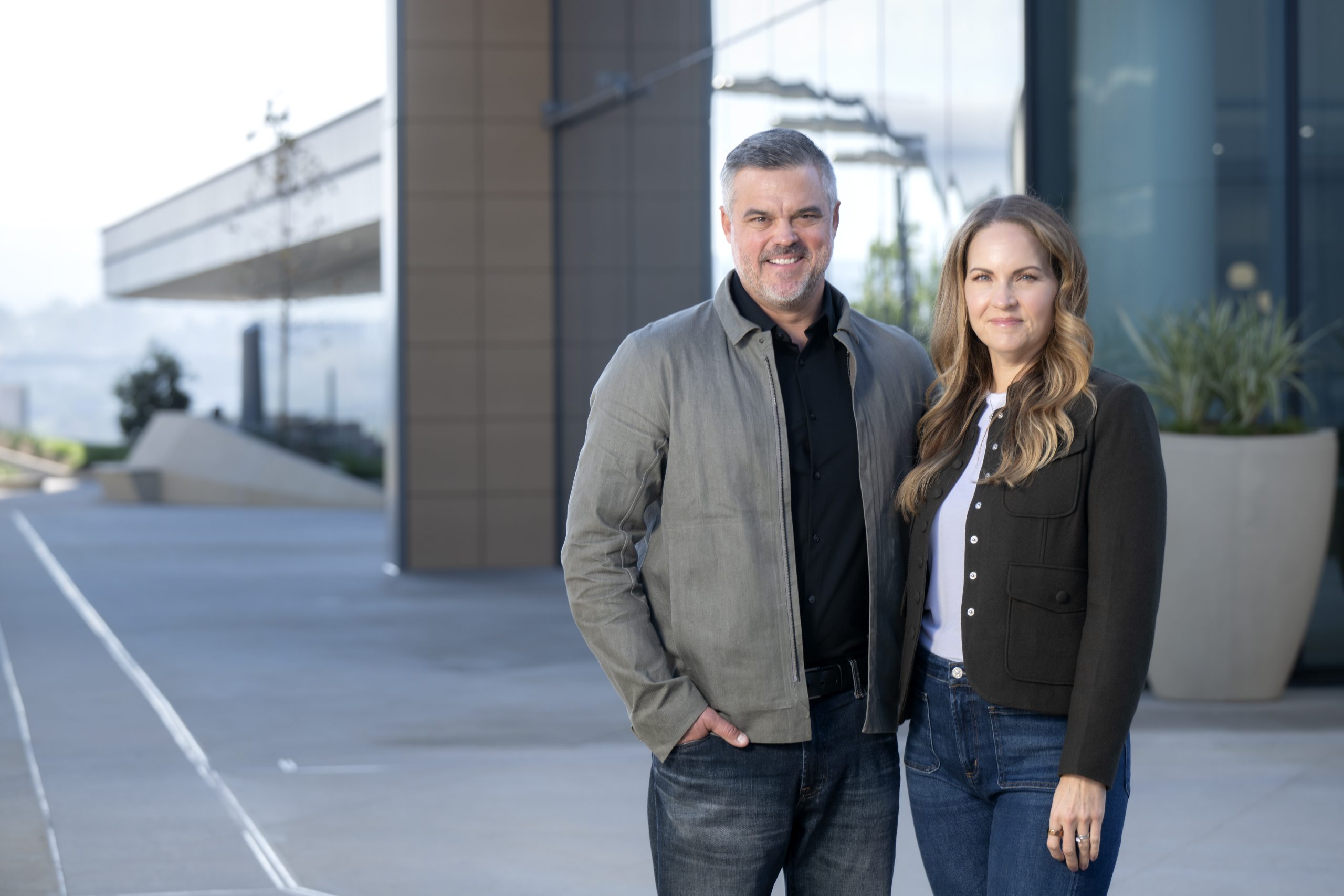 A couple poses in front of a university hospital building