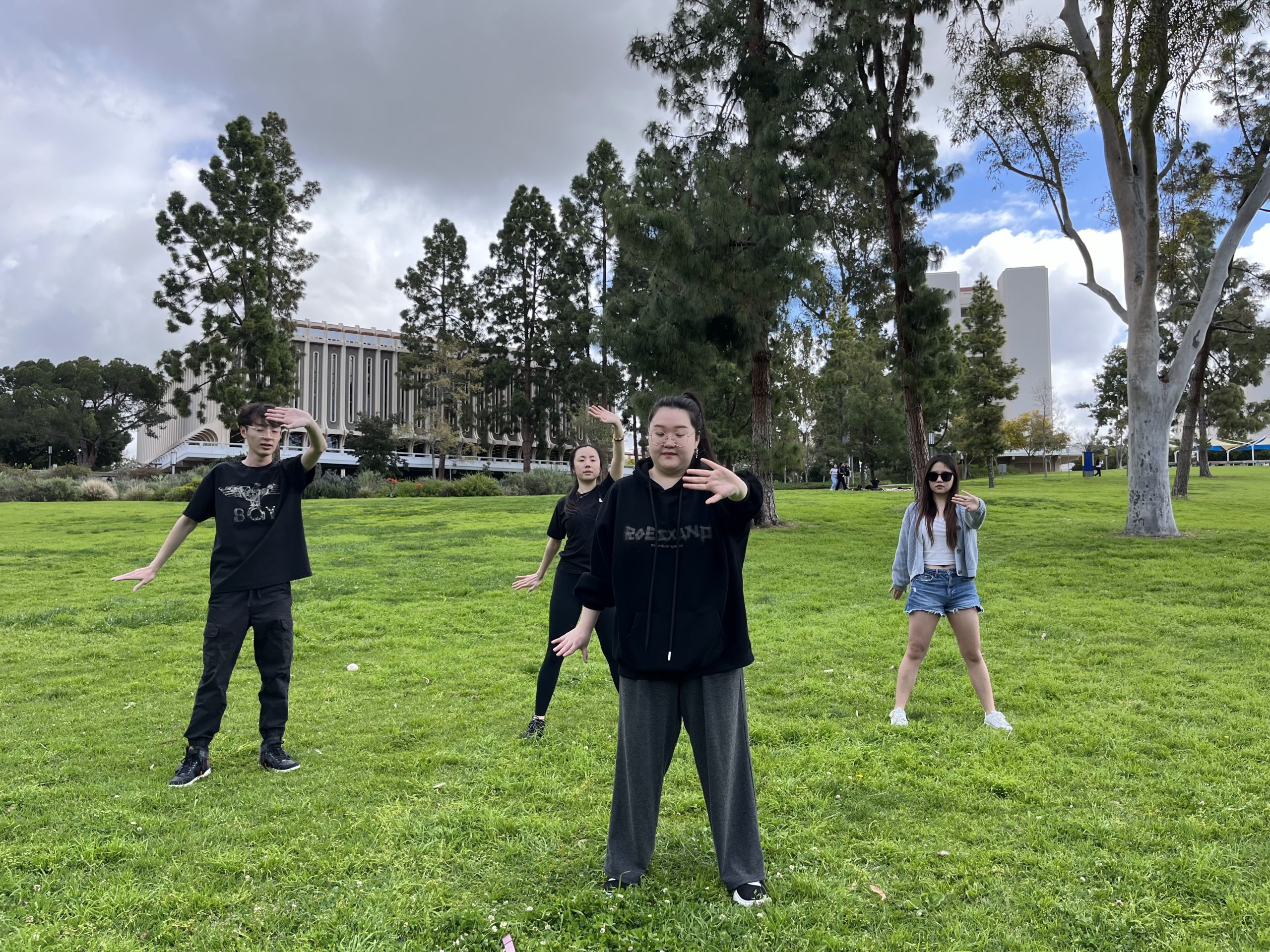 People practice tai chi on the lawn during Happiness Week