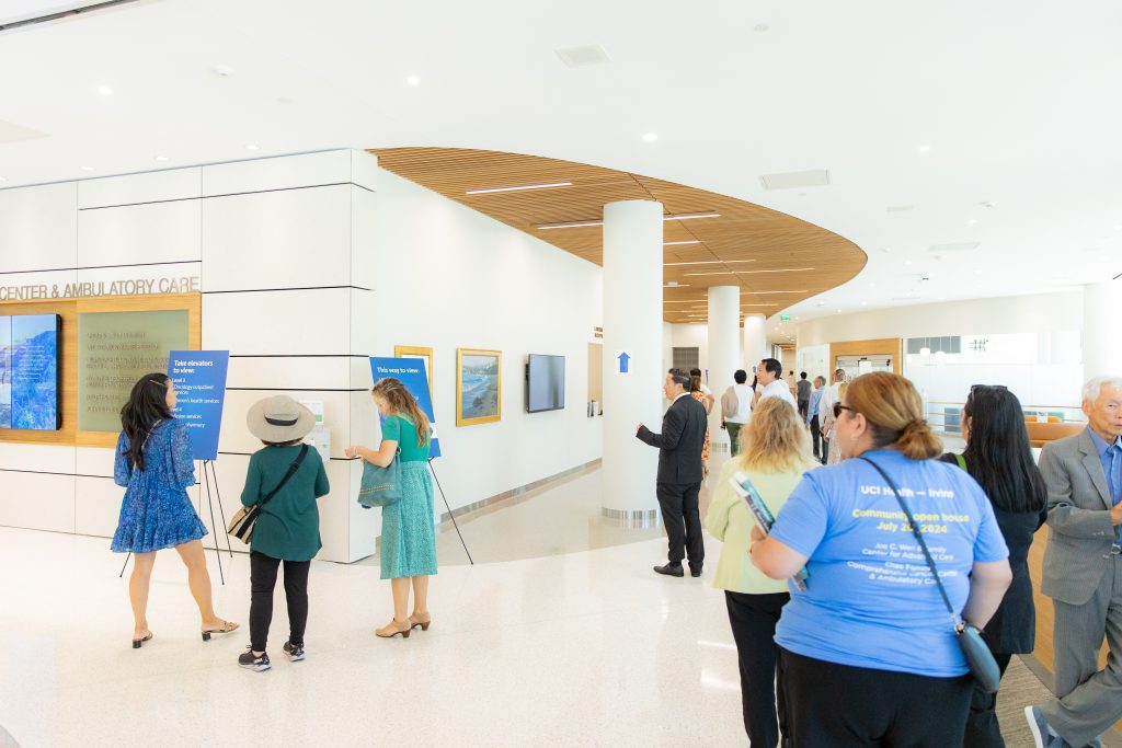 A crowd of people explore a hospital lobby