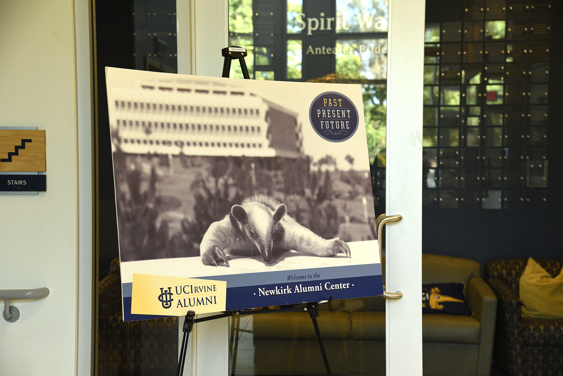 Display sign featuring the UC Irvine Alumni anteater mascot and a welcome message at the Newkirk Alumni Center.