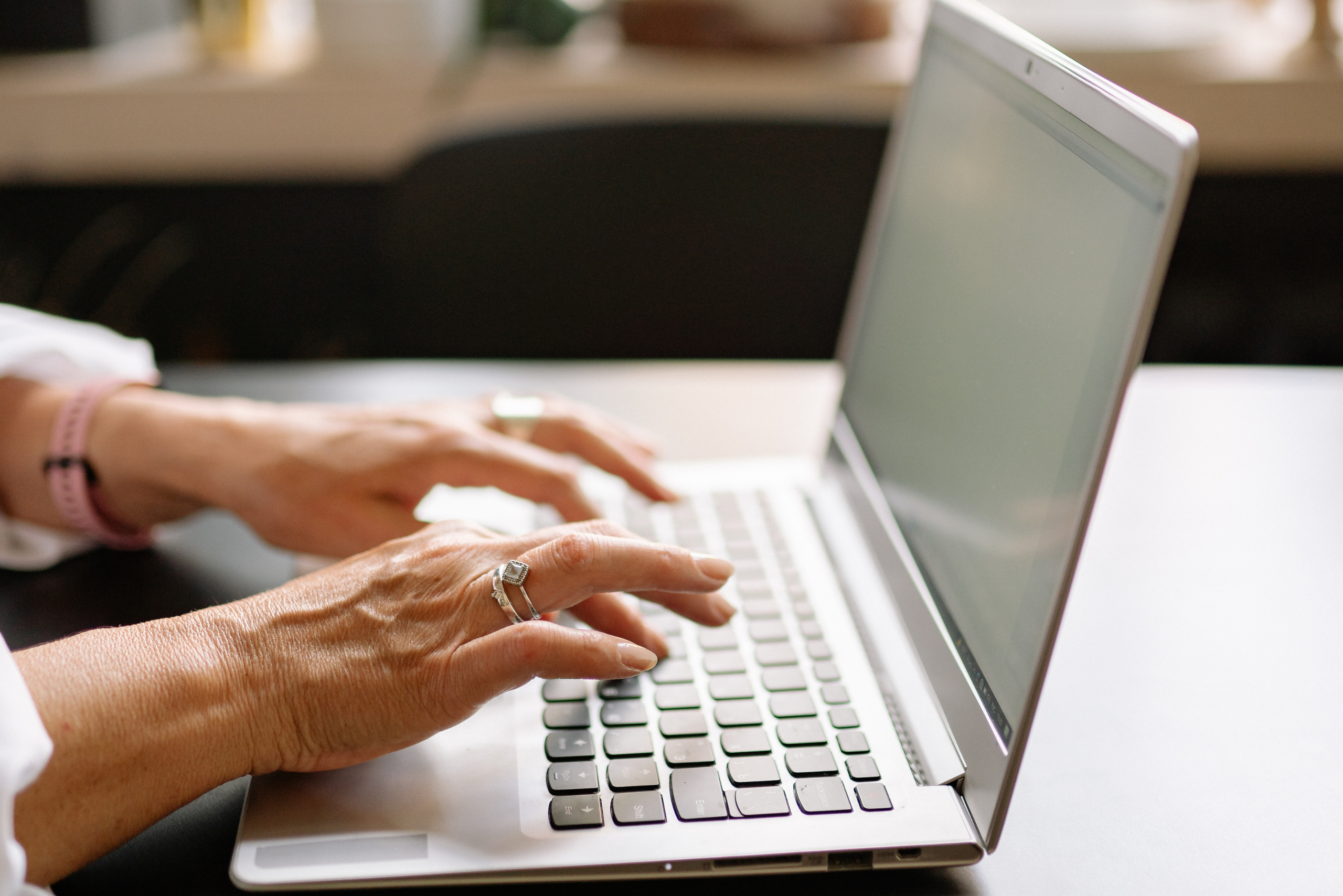 Person Using a Laptop on Table